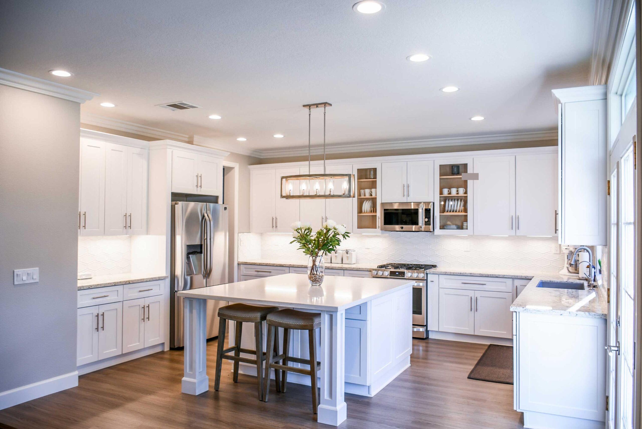 Bright white kitchen with LED ceiling lighting and eco-friendly finishes