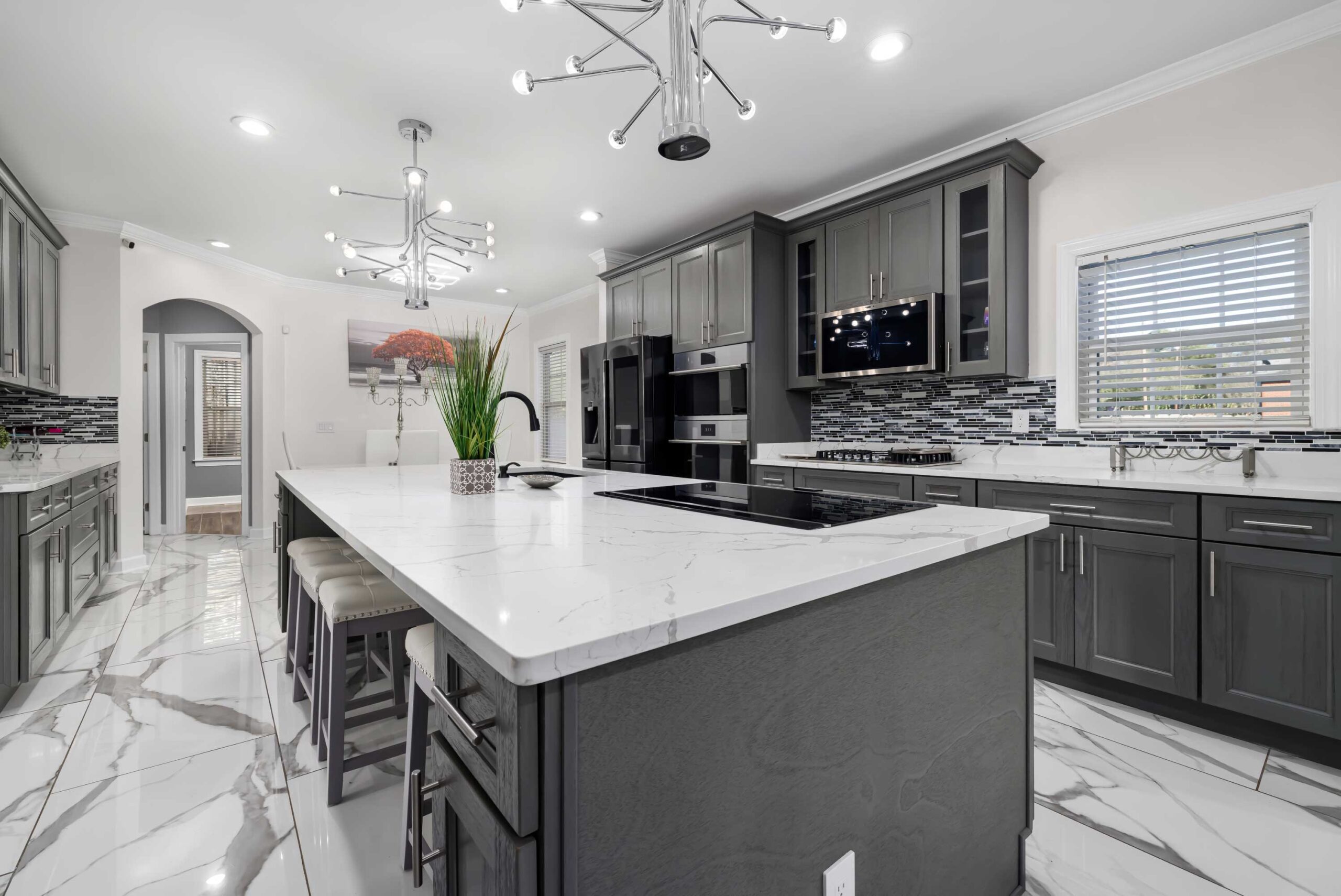 Modern kitchen island with quartz countertop and built-in cooktop