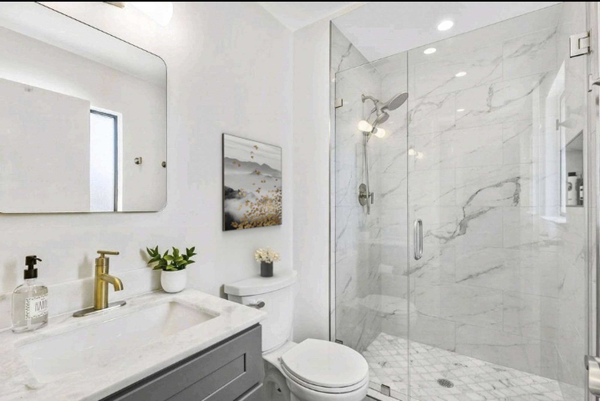 Laguna-Niguel bathroom remodel with marble tile, shower and a gray vanity