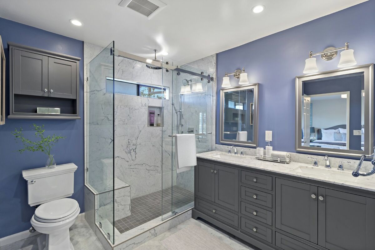 Bathroom remodel in Mission Viejo featuring purple walls, gray vanity, marble shower by USA Home Remodeling