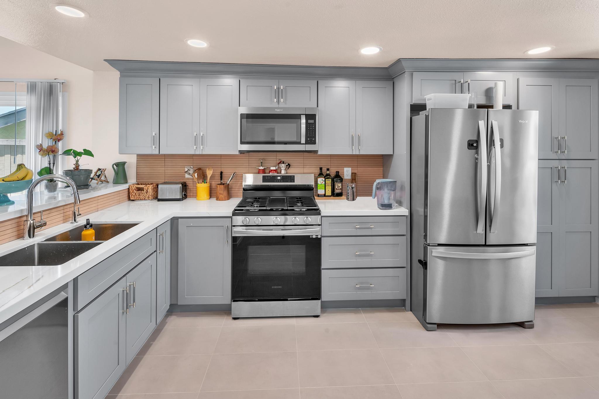 Carlsbad kitchen remodel with gray shaker cabinets, white quartz countertops, and stainless steel appliances by USA Home Remodeling