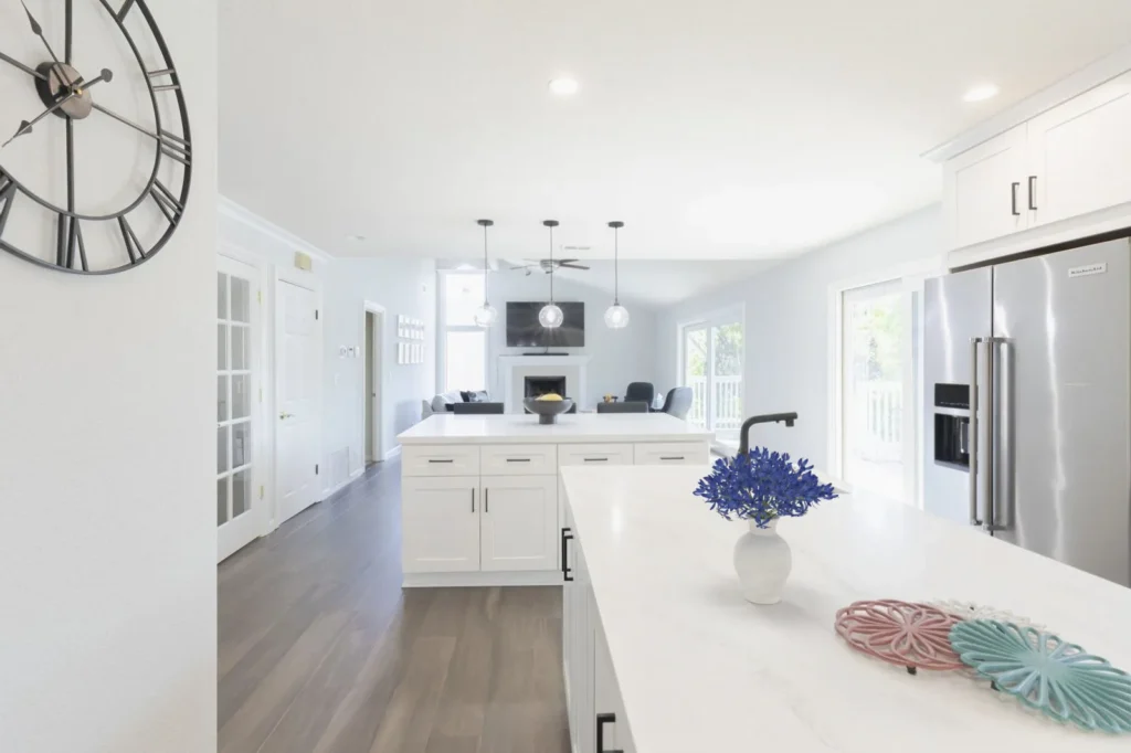 Newport Beach kitchen remodel with dual islands, white shaker cabinets, quartz countertops, and open-concept living area