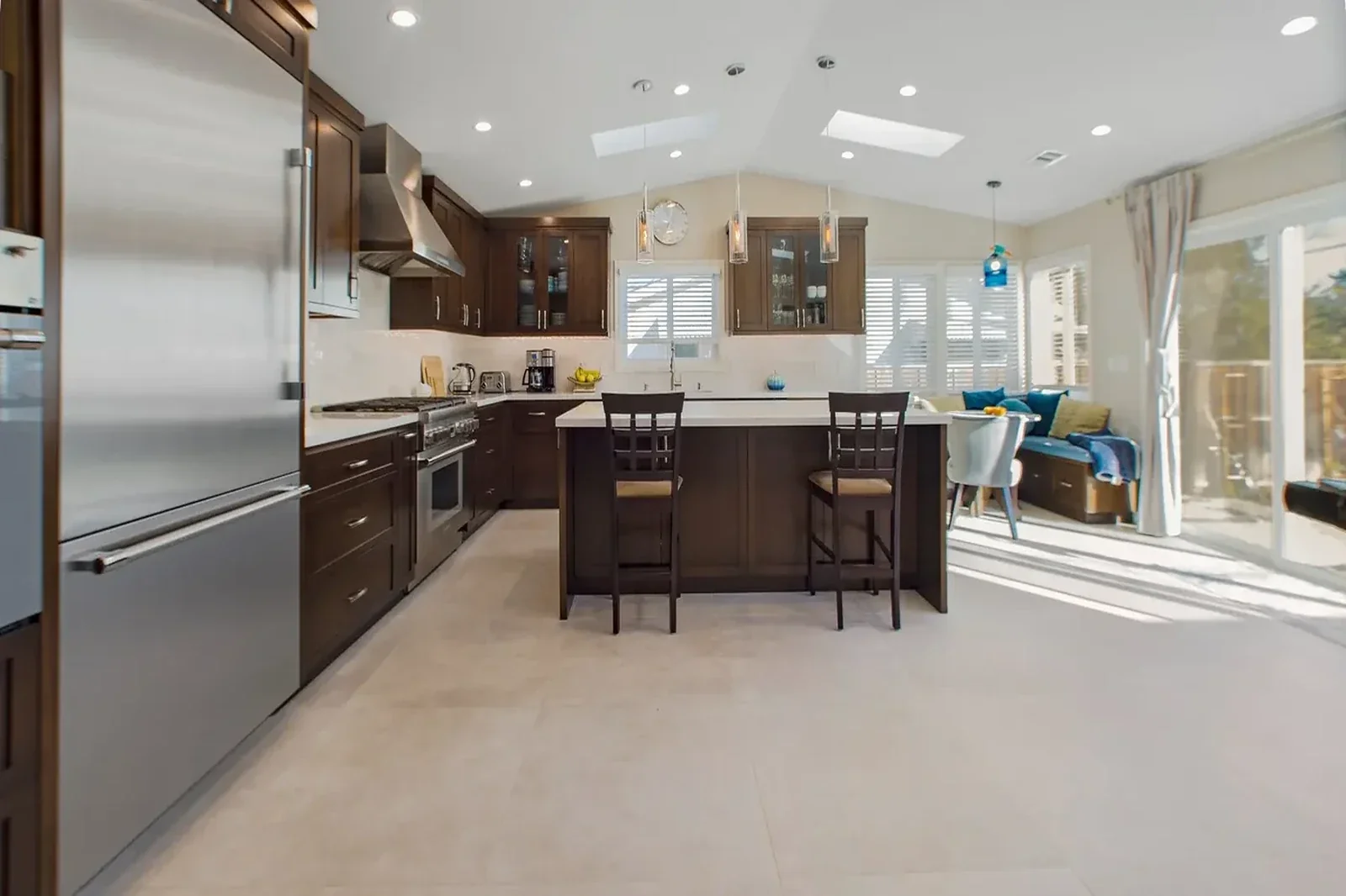 Irvine kitchen remodel - Espresso cabinets, quartz countertops, pendant lights, skylights, breakfast nook