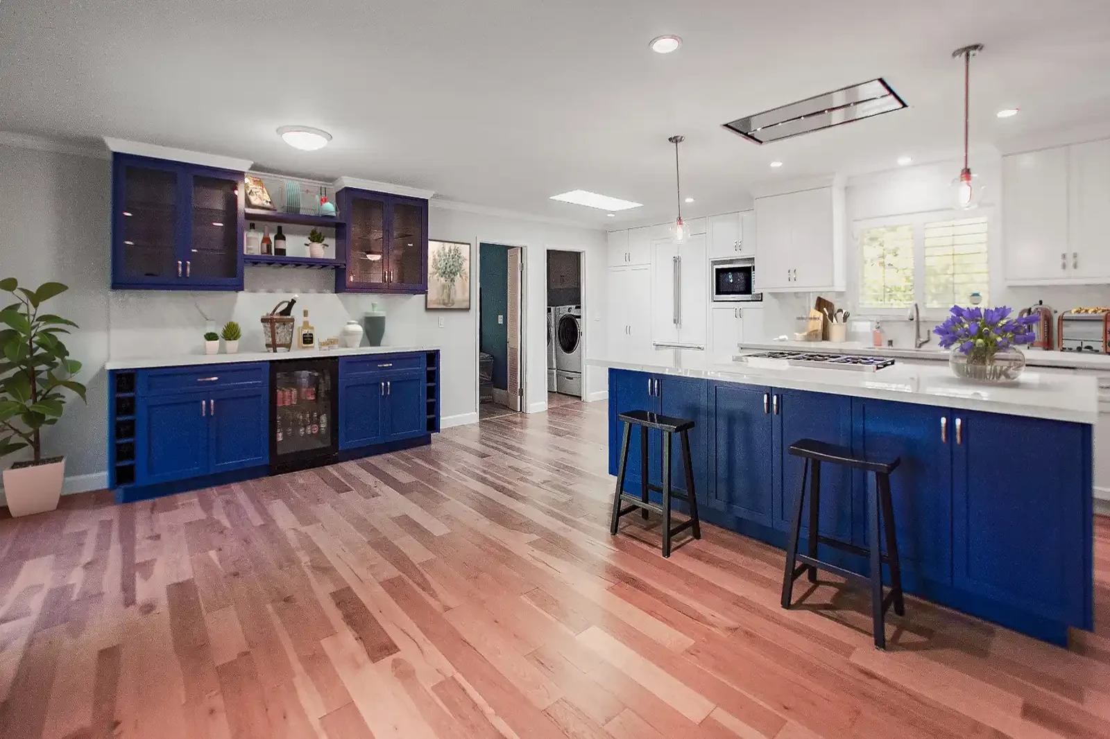 Laguna Niguel kitchen remodel - Bold blue cabinets, blue island, hardwood floors, wine storage, open layout