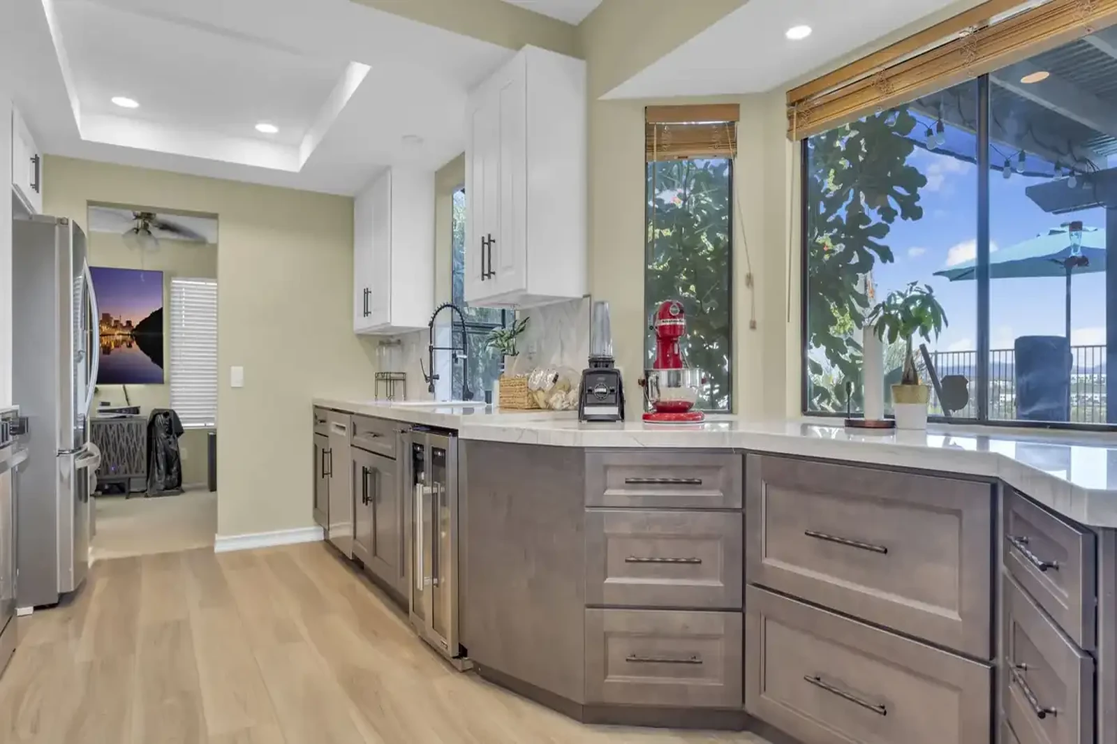 Oceanside kitchen remodel - Two-tone gray and white cabinets, quartz countertops, garden window view