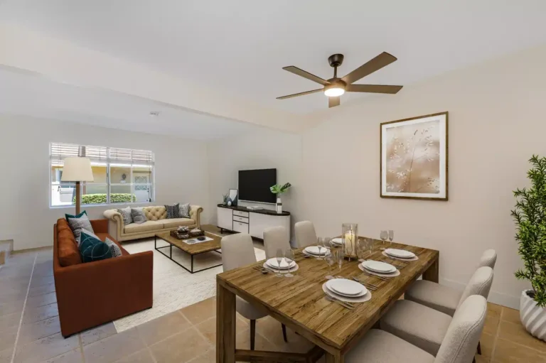 Bright Irvine living and dining area with modern furnishings, tiled flooring, ceiling fan, and large front window.