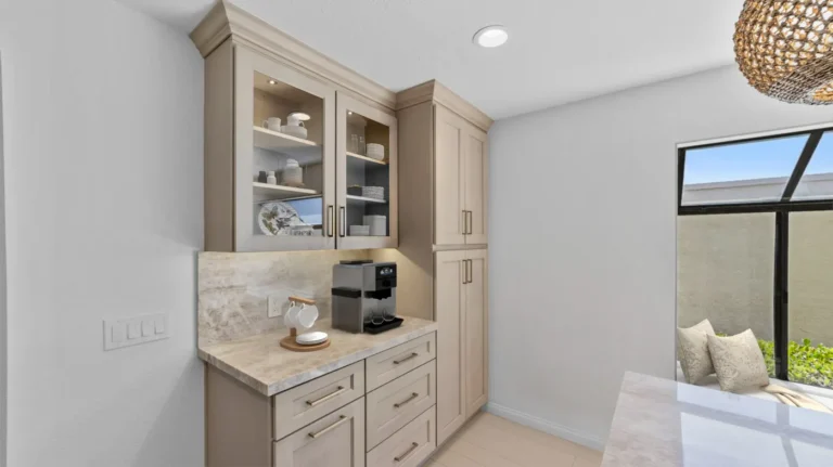 Built-in coffee station with glass-front cabinets in a finished kitchen remodel in Carlsbad.