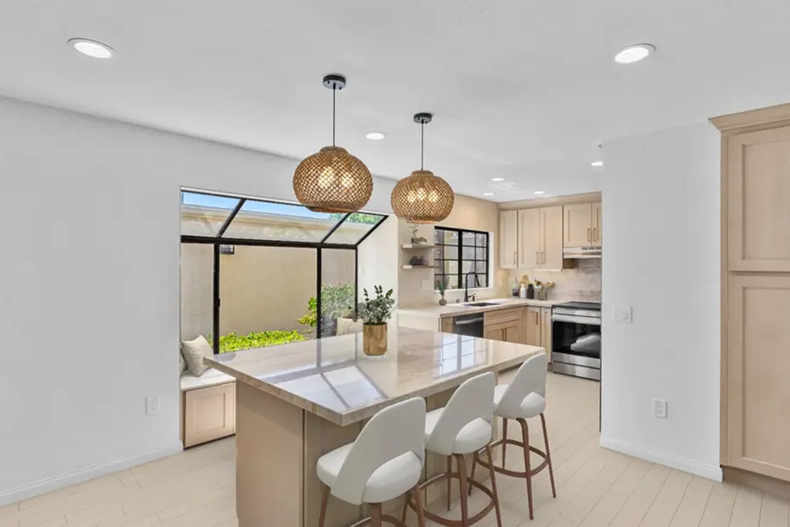 Poway kitchen remodel with light oak cabinets, a quartzite island, and pendant lighting