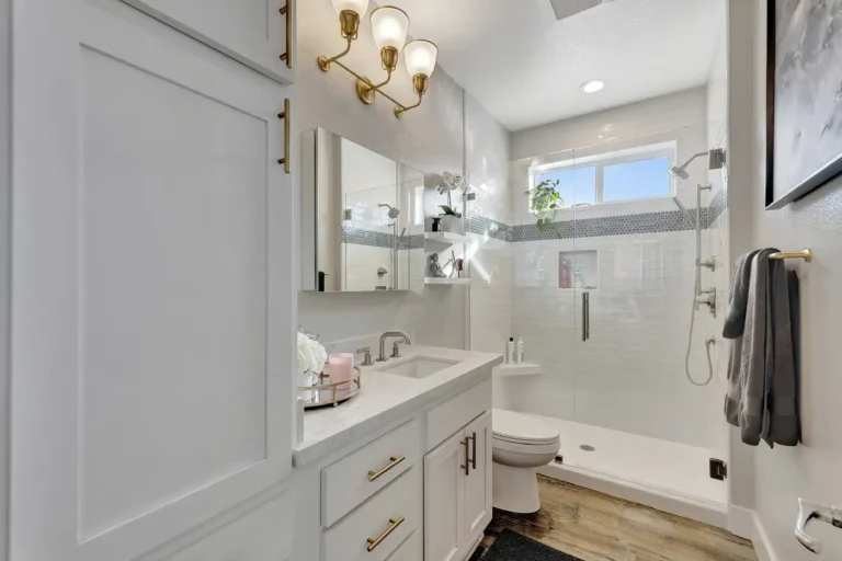 White shaker vanity and frameless glass walk-in shower in a remodeled Newport Beach master bathroom