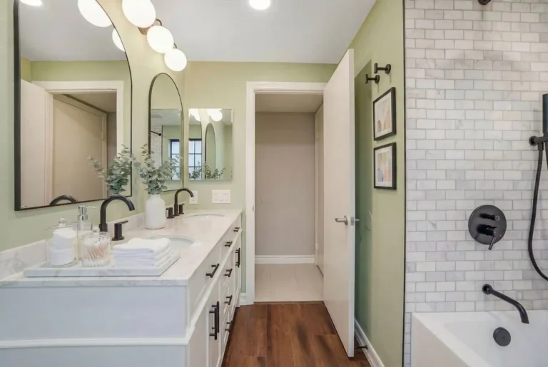 Irvine bathroom remodel with a double vanity, stylish black fixtures, and a subway tile shower offering a luxurious, modern feel.
