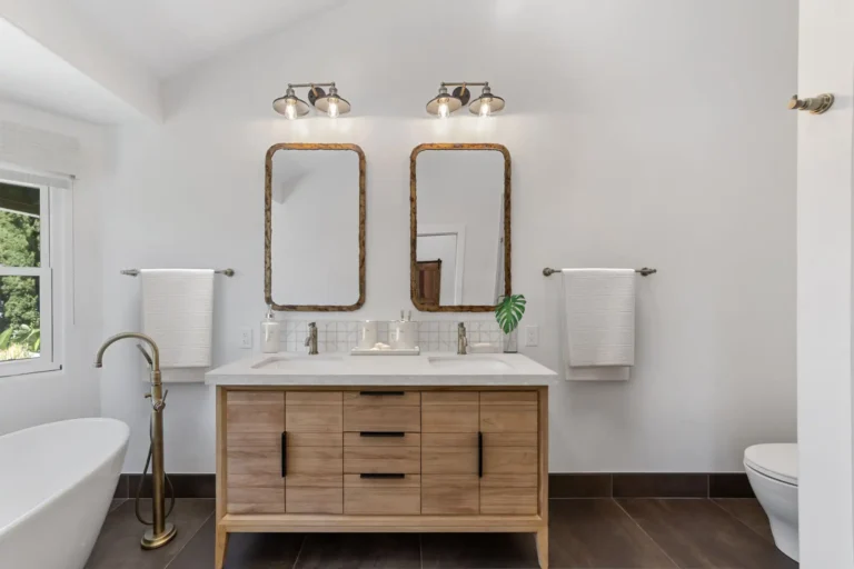 Wood double vanity with twin rustic framed mirrors in a Santa Ana master bathroom remodel