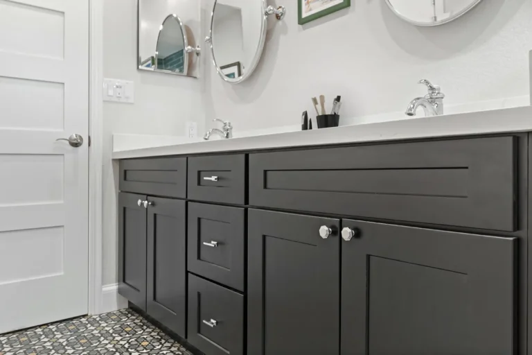 Chrome bar pulls and octagonal knobs on charcoal shaker vanity cabinets in a remodeled Anaheim guest bathroom.