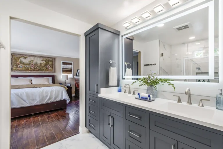 Full-height linen tower beside a double-sink vanity in a bathroom remodel in Irvine, California
