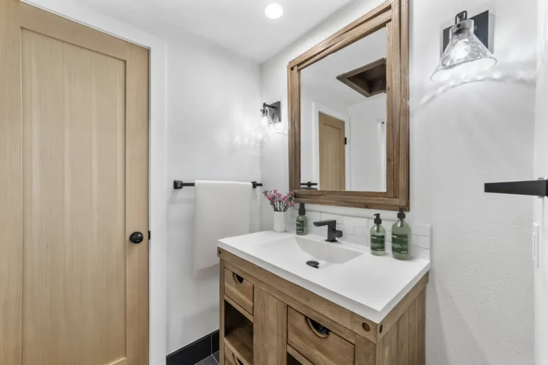 Undermount sink and matte black faucet on a quartz vanity top in a Santa Ana bathroom remodel