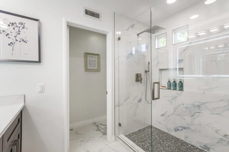 Frameless glass walk-in shower beside the private toilet room in an Irvine, California bathroom