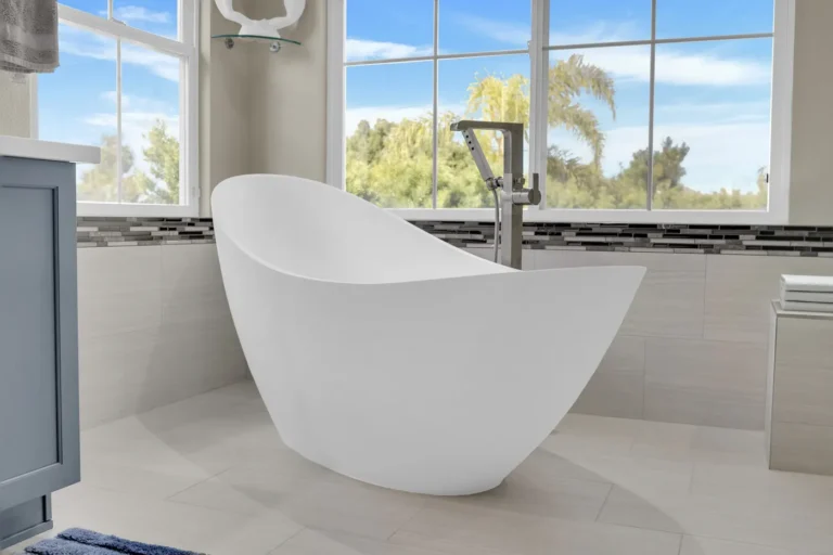 Sculptural freestanding soaking tub with a brushed nickel floor-mounted filler in a Carlsbad bathroom remodel