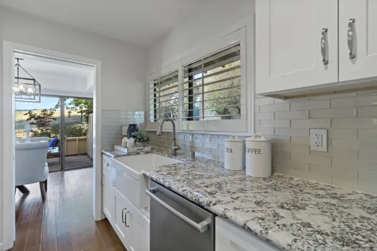 Glossy subway tile backsplash runs to the dining room doorway in this remodeled Laguna Hills kitchen