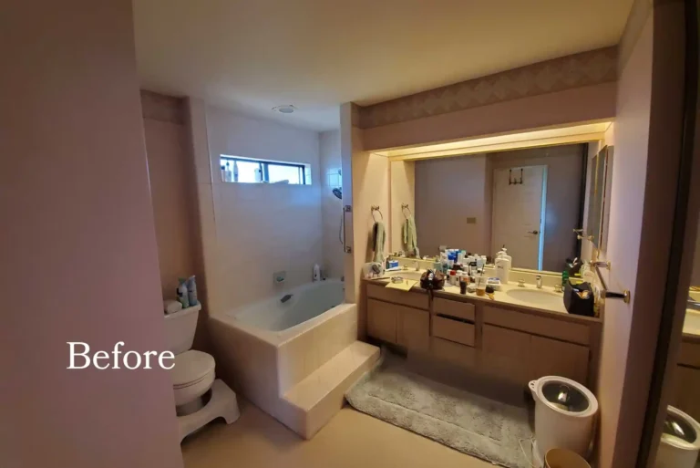 Bathroom before remodel with tub–shower combo and dated vanity.