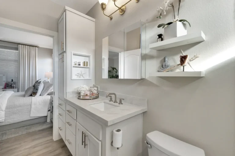 Tall linen tower and recessed display niche beside the vanity in a Newport Beach master bathroom