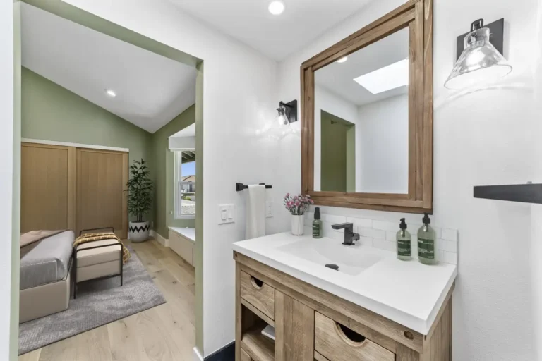 Vanity area opening onto the bedroom with a skylight reflected in the mirror, Santa Ana bathroom remodel