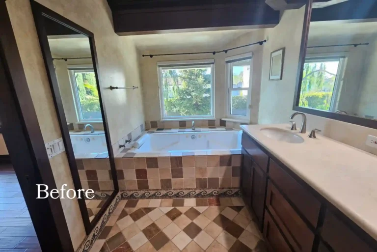 Before photo of a dated Santa Ana master bathroom with a tiled drop-in tub and dark wood vanity