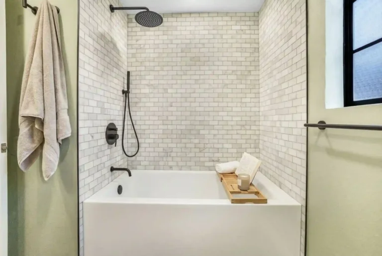 Contemporary bathroom remodel in Irvine with subway tile shower, black fixtures, and modern design elements for a stylish, functional space.