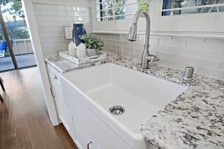 Close view of the deep white sink basin and pull down faucet in a remodeled Laguna Hills kitchen