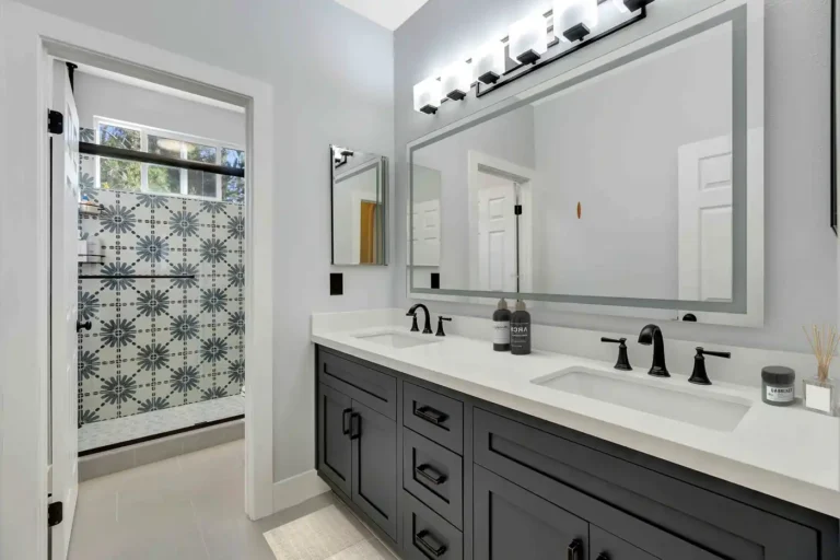 Charcoal Shaker double vanity with white quartz counters and oil-rubbed bronze faucets in a remodeled San Clemente bathroom.