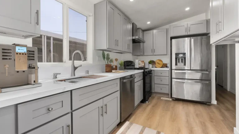 Galley layout with gray shaker cabinets, quartz countertops, and stainless appliances in a Torrance kitchen remodel