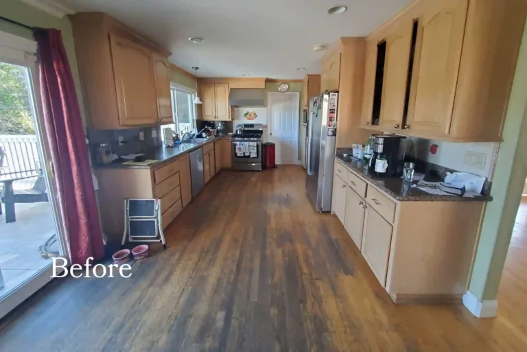 Before photo of a dated Newport Beach kitchen with oak arched cabinets, dark granite counters, and a worn wood floor