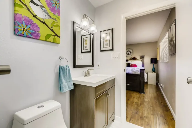 Shaker vanity with white quartz countertop and framed mirror in a Newport Beach bathroom remodel