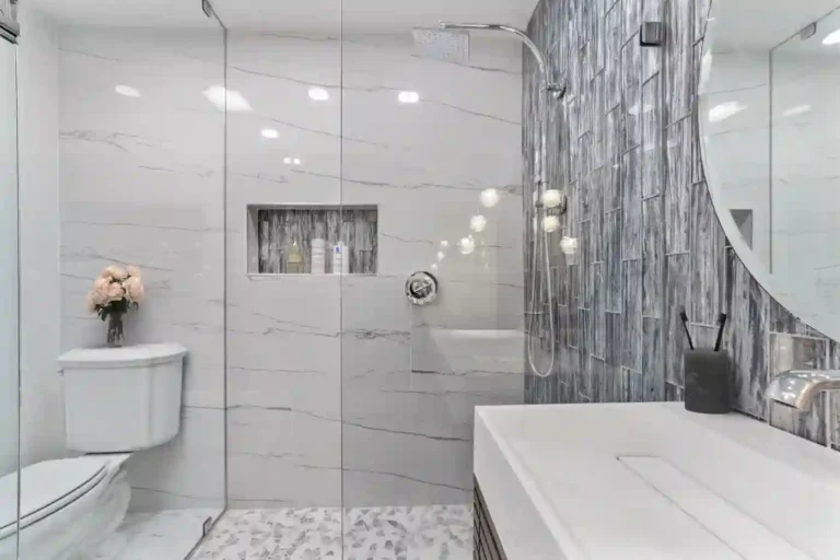 Rain showerhead and handheld sprayer in a walk-in shower with a tiled niche in a Santa Ana guest bathroom remodel