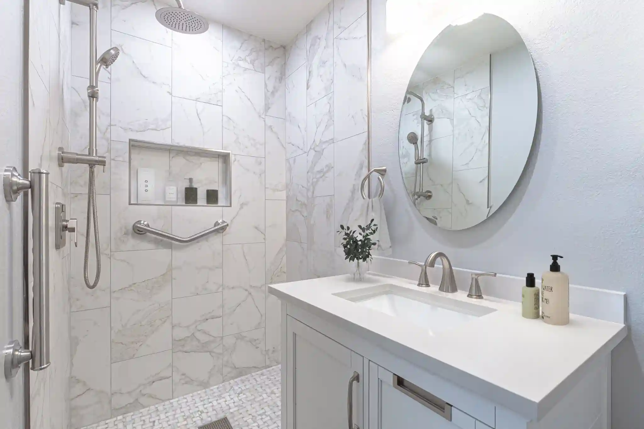 Walk-in shower with marble-look tile, rain head and a mosaic floor in a Mission Viejo bathroom remodel