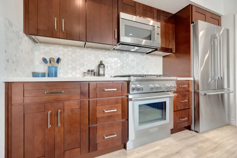 Stainless microwave, pro gas range and French door fridge set in walnut shaker cabinets in a Mission Viejo kitchen