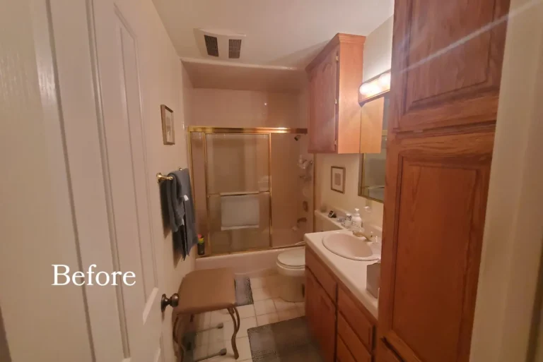 Before photo of the Mission Viejo guest bathroom with brass-framed shower doors, oak cabinets, and beige tile