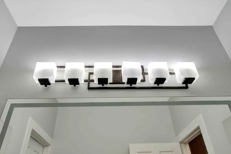 Six-light vanity bar with frosted cube glass shades above the mirror in a San Clemente bathroom remodel.