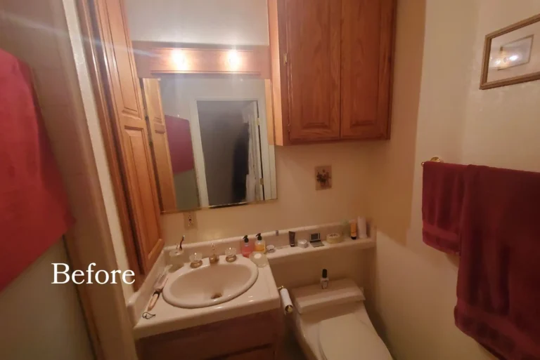 Before photo of a dated Mission Viejo bathroom with wood cabinets, cultured marble top and strip lighting