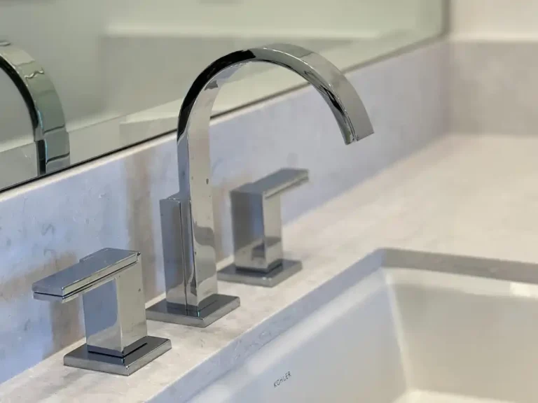 Chrome widespread faucet above an undermount sink and quartz countertop in an Aliso Viejo bathroom remodel.