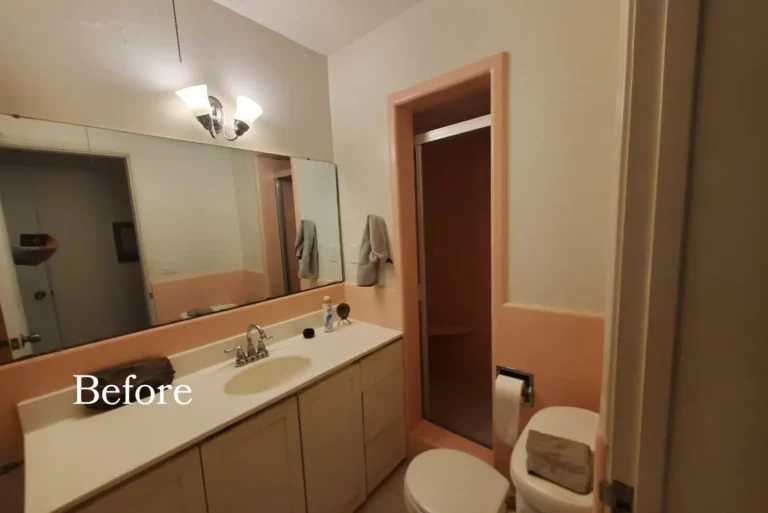 Before remodel: dated Irvine bathroom with peach wainscot tile, a long light wood vanity and a full width mirror