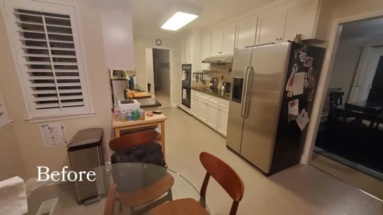 Before photo of the original Laguna Niguel galley kitchen with a stainless side-by-side refrigerator and tile backsplash