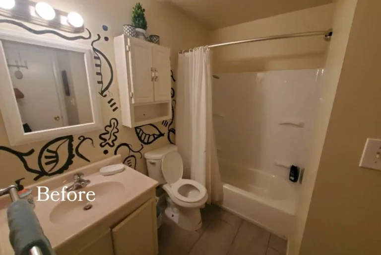 Before photo of the dated San Clemente guest bathroom with a beige vanity, painted wall art and fiberglass tub surround