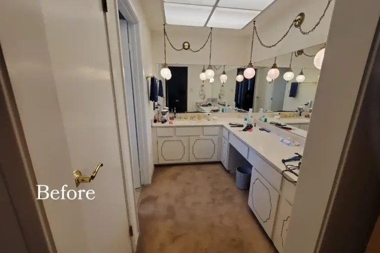 Dated vanity with carpet flooring and brass pendant lights in an Aliso Viejo bathroom before remodeling.
