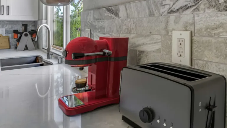 Veined gray subway tile backsplash behind a red espresso machine and toaster on white quartz in an Irvine kitchen.