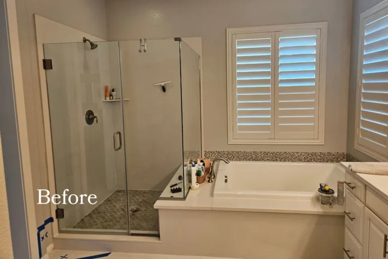 Before photo of a dated Ladera Ranch primary bathroom with a glass shower enclosure, drop-in tub deck, and mosaic band.