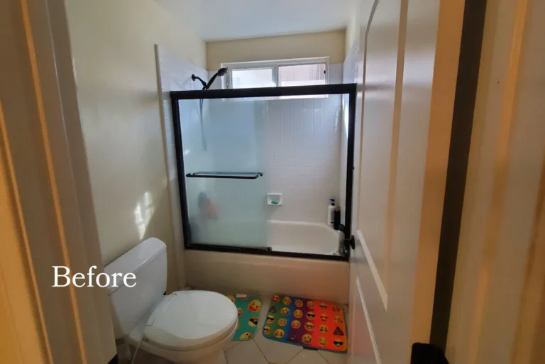 Before photo of the original San Clemente bathroom vanity with a tiled countertop and dated yellow wall paint