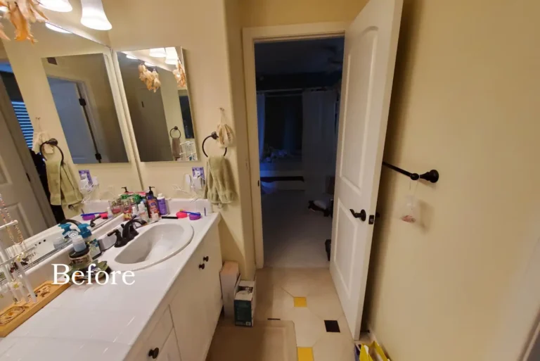 Before photo of the original San Clemente bathroom with a tub and shower combo behind framed sliding glass doors