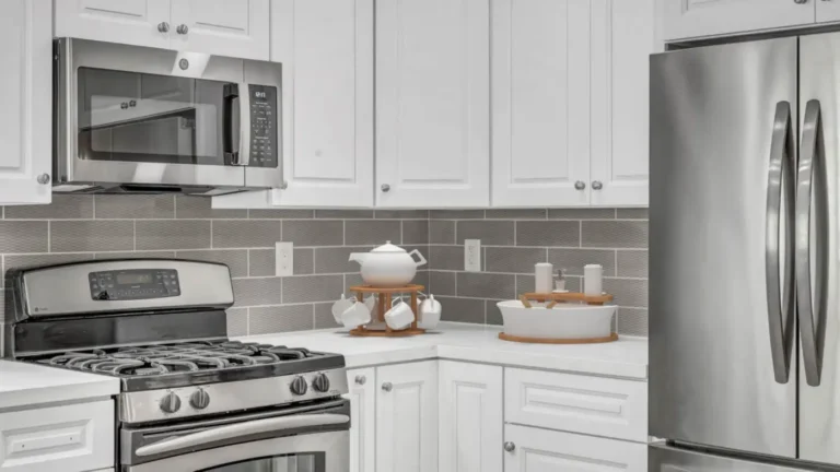 Gray textured tile backsplash wrapping a quartz corner counter beside a French door refrigerator in Santa Ana