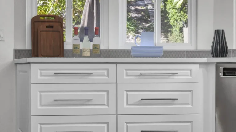 White raised panel drawer bank with long bar pulls under a quartz countertop in a Santa Ana kitchen remodel